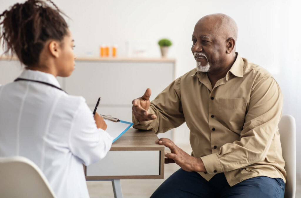 A doctor with a clipboard conducts a capacity assessment with a smiling patient.