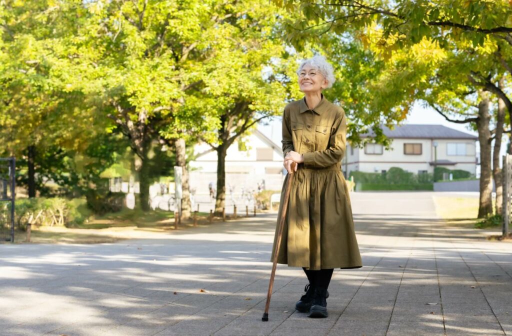 Someone walks along the pathway of an urban green space.