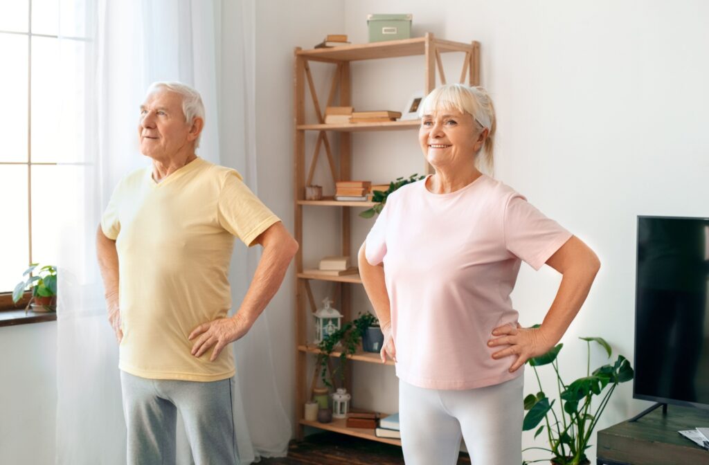 A senior couple standing and exercising together